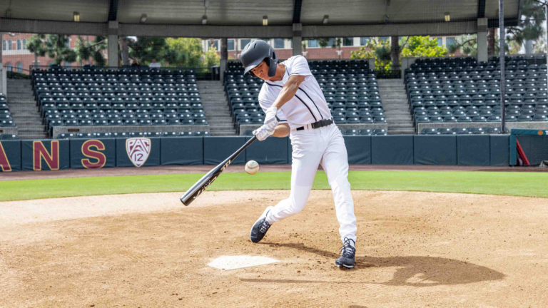 Pictured is a high school baseball player hitting a baseball